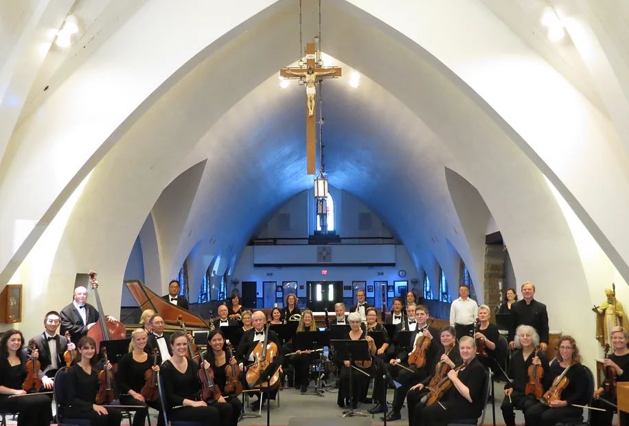 Lexington Bach Festival orchestra smiling at camera in Ave Maria Parish