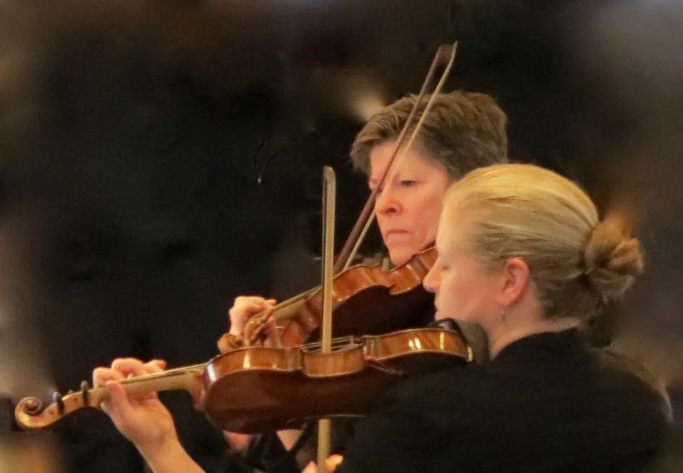 violinist playing in an orchestra