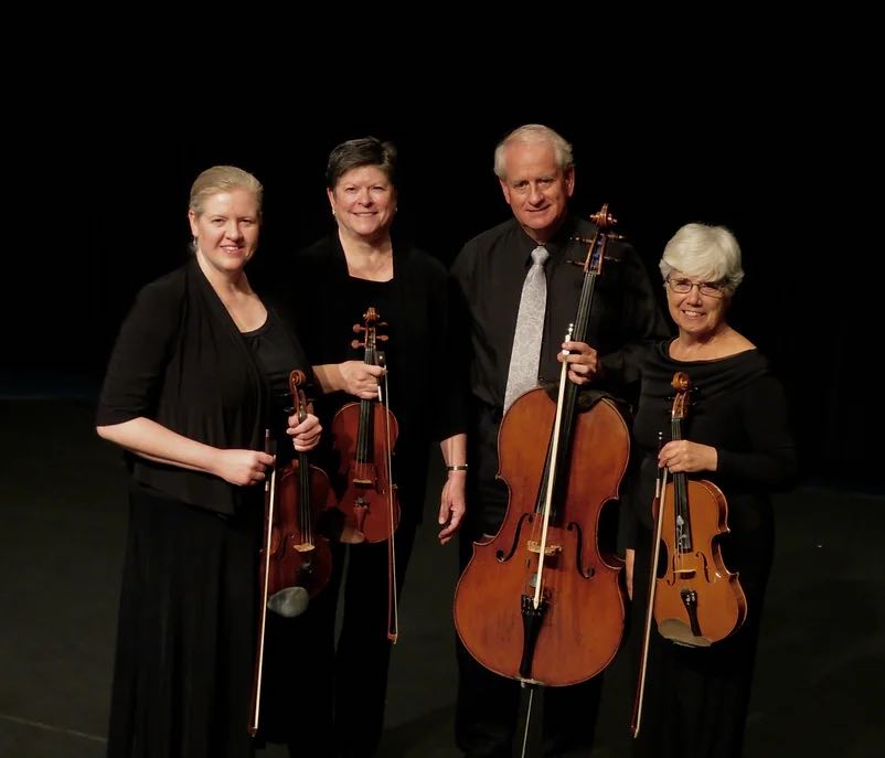 string quartet members holding their instruments