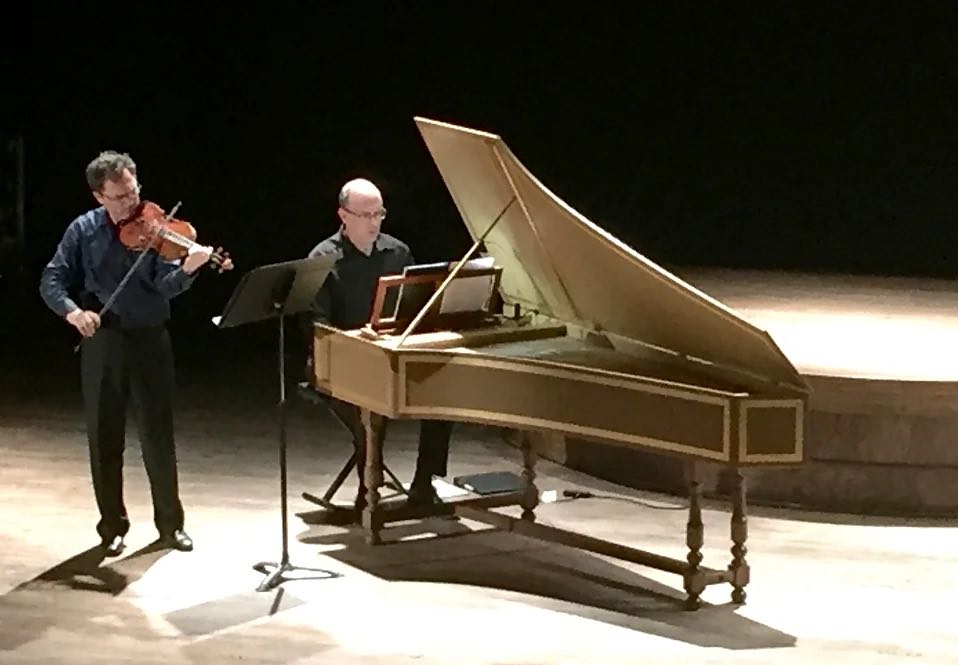 Pianist and violinist playing on stage