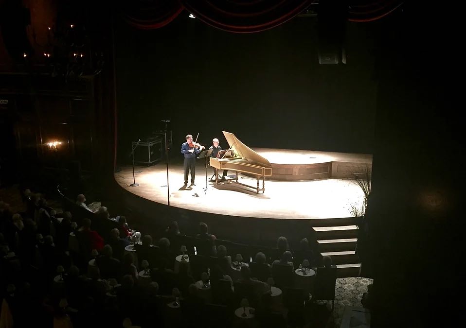 wide shot of violinist and pianist performing on stage