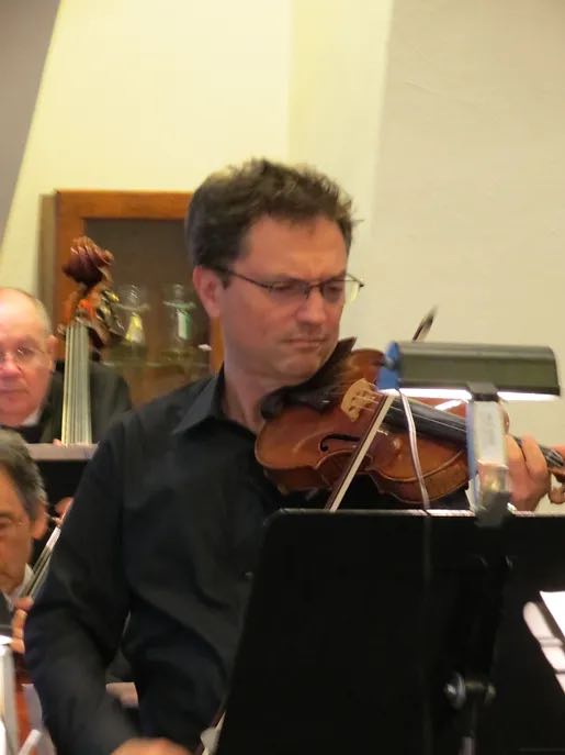 violinist performing in an orchestra