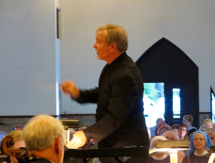 orchestra conductor in action in front of audience