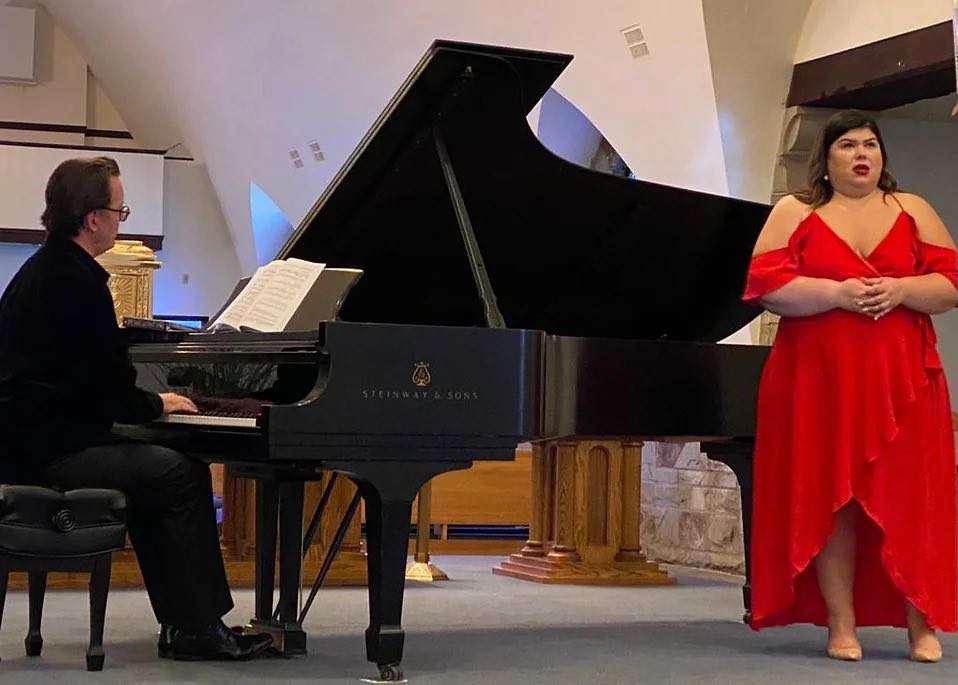 pianist playing and opera singer in red dress singing