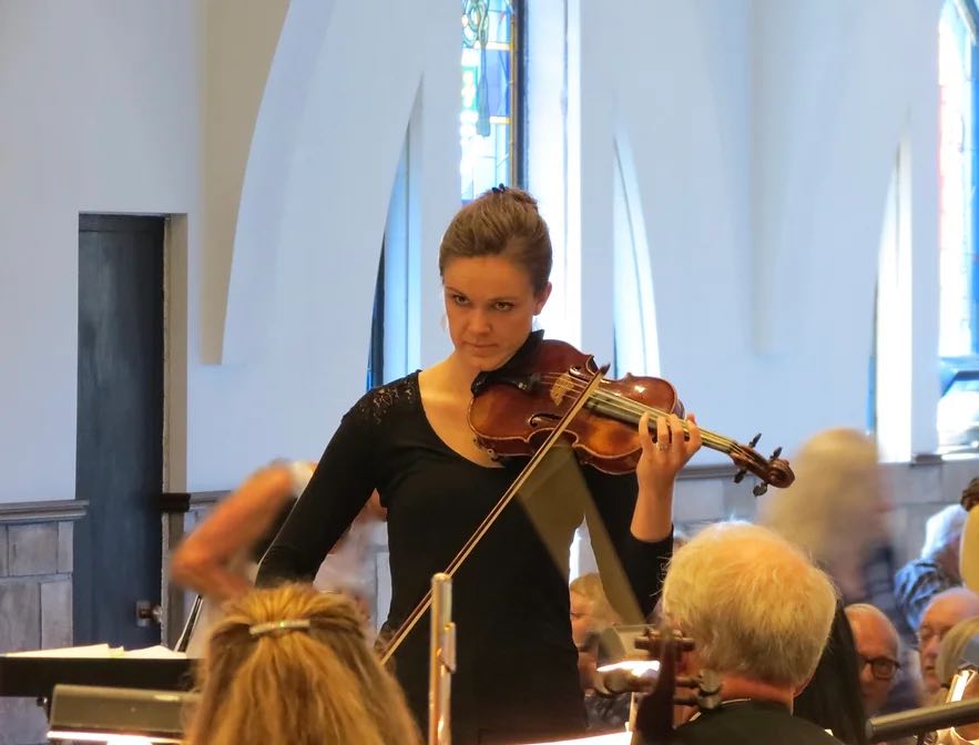 violinist playing while looking up at the audience