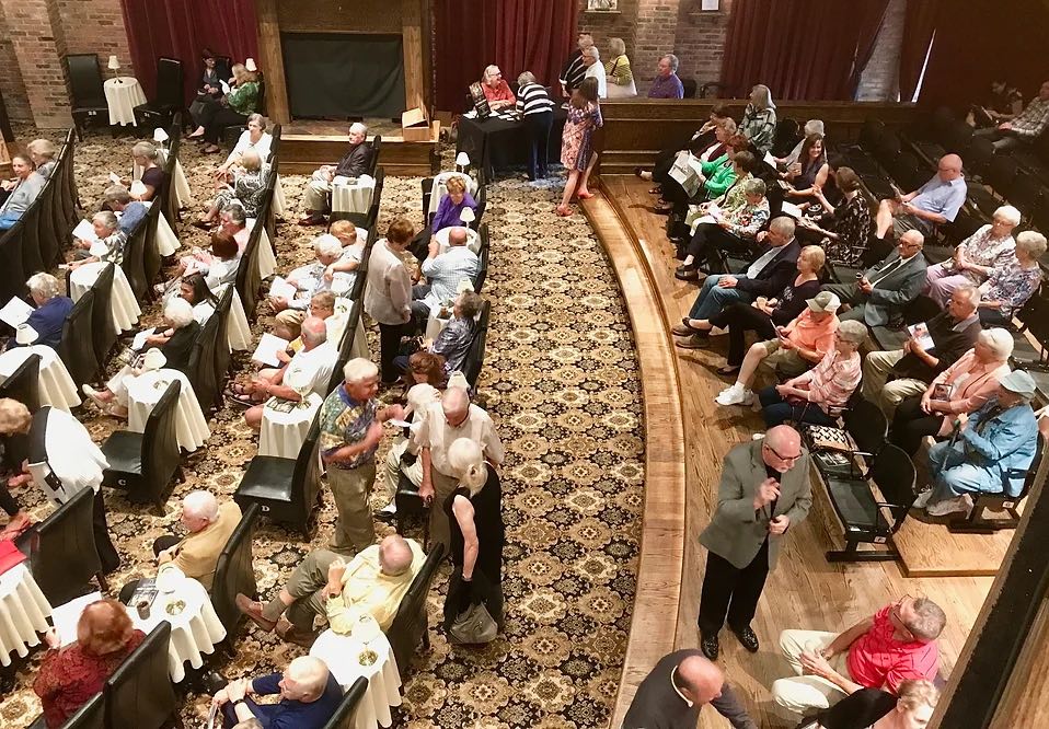 top angled view of audience mingling in the Lexington Village Theatre