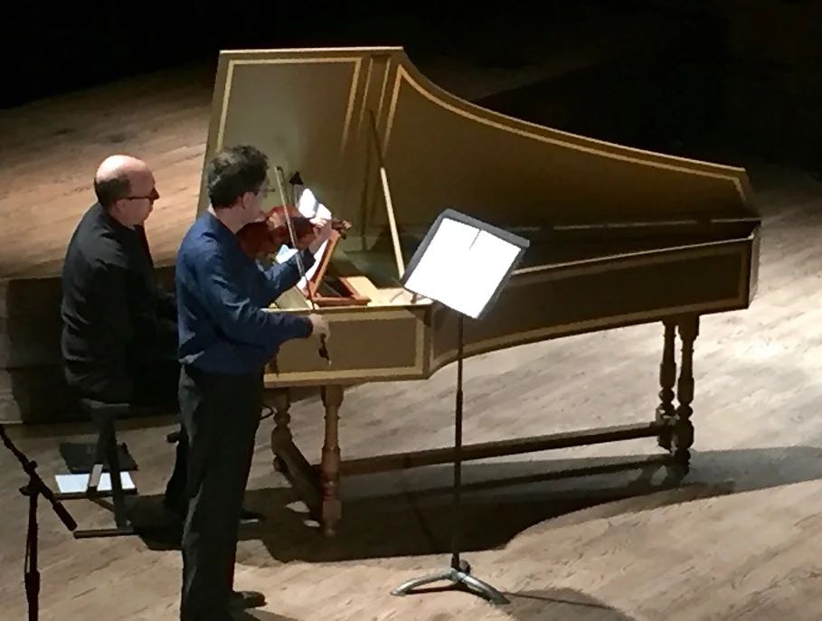 pianist and violinist playing on stage