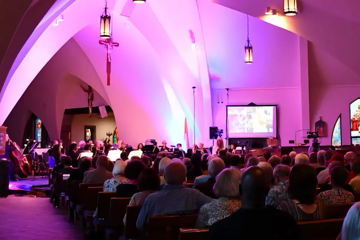 Bach Festival orchestra playing in front of a crowd at St. Denis church